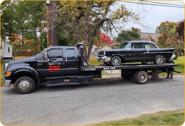Barnes Auto & Towing flatbed tow truck transporting a classic car in Charles City, VA